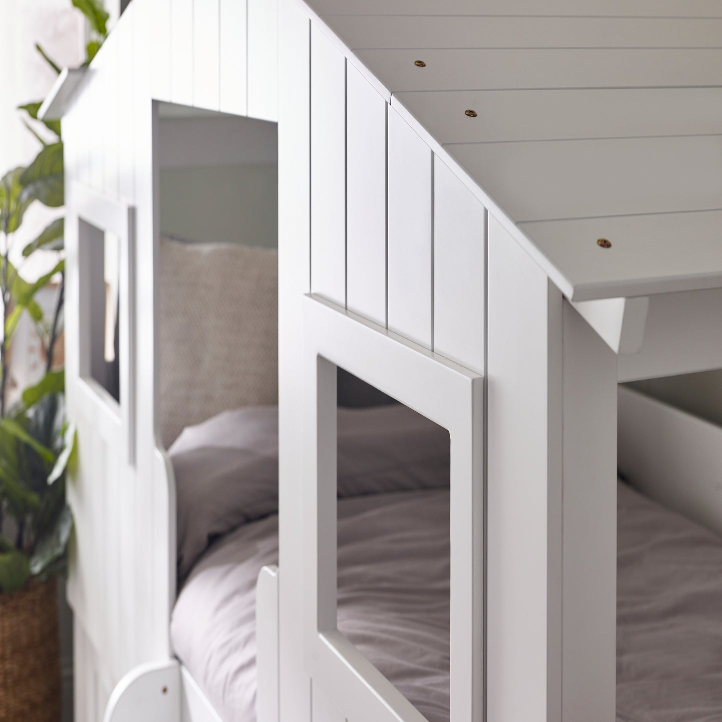 Window detail of a white treehouse mid sleeper bed