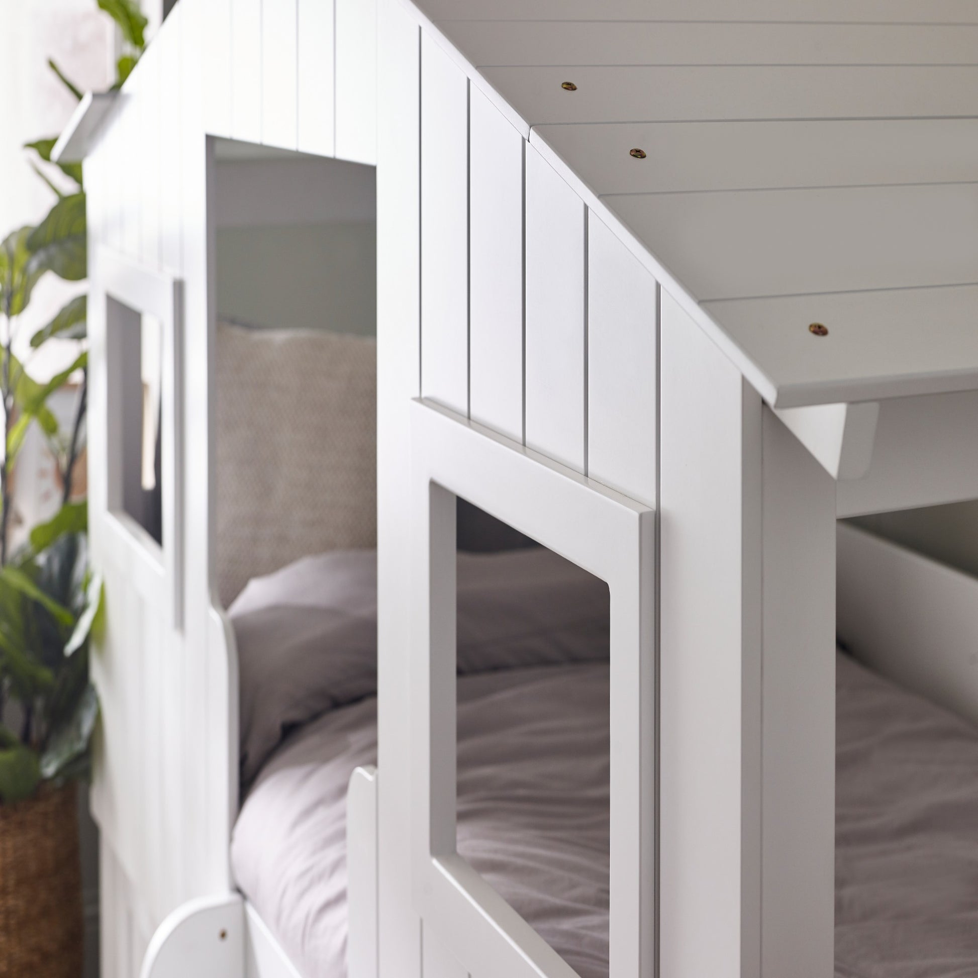 Window detail of a white treehouse mid sleeper bed