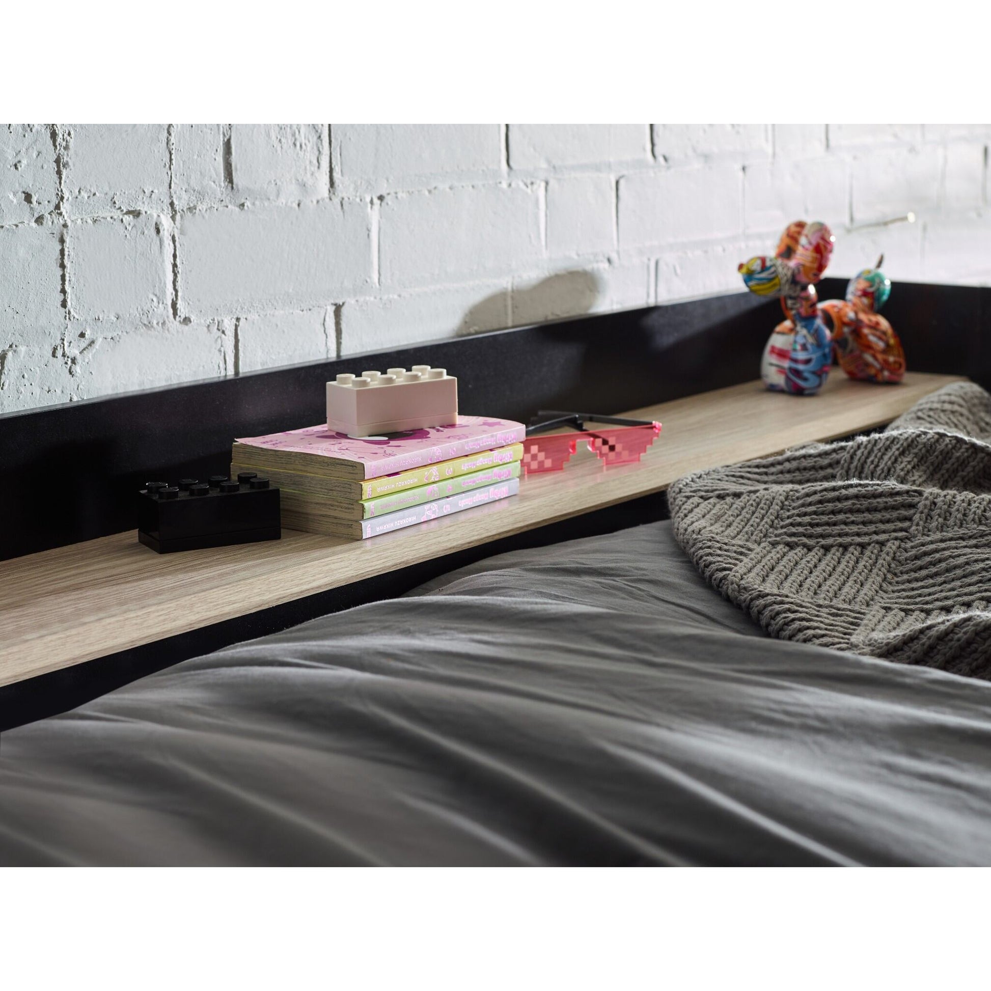 Upper bunk shelf detail of Blaze High Sleeper Gaming Bed in black and pale wood