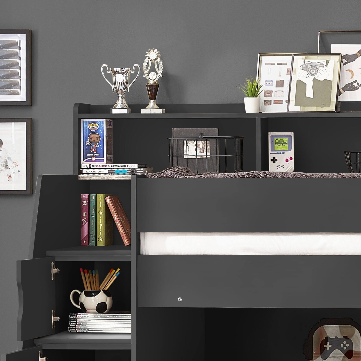 Dark grey Camelot bunk bed, close up of open storage compartments and shelving, dressed with books and picture frames.