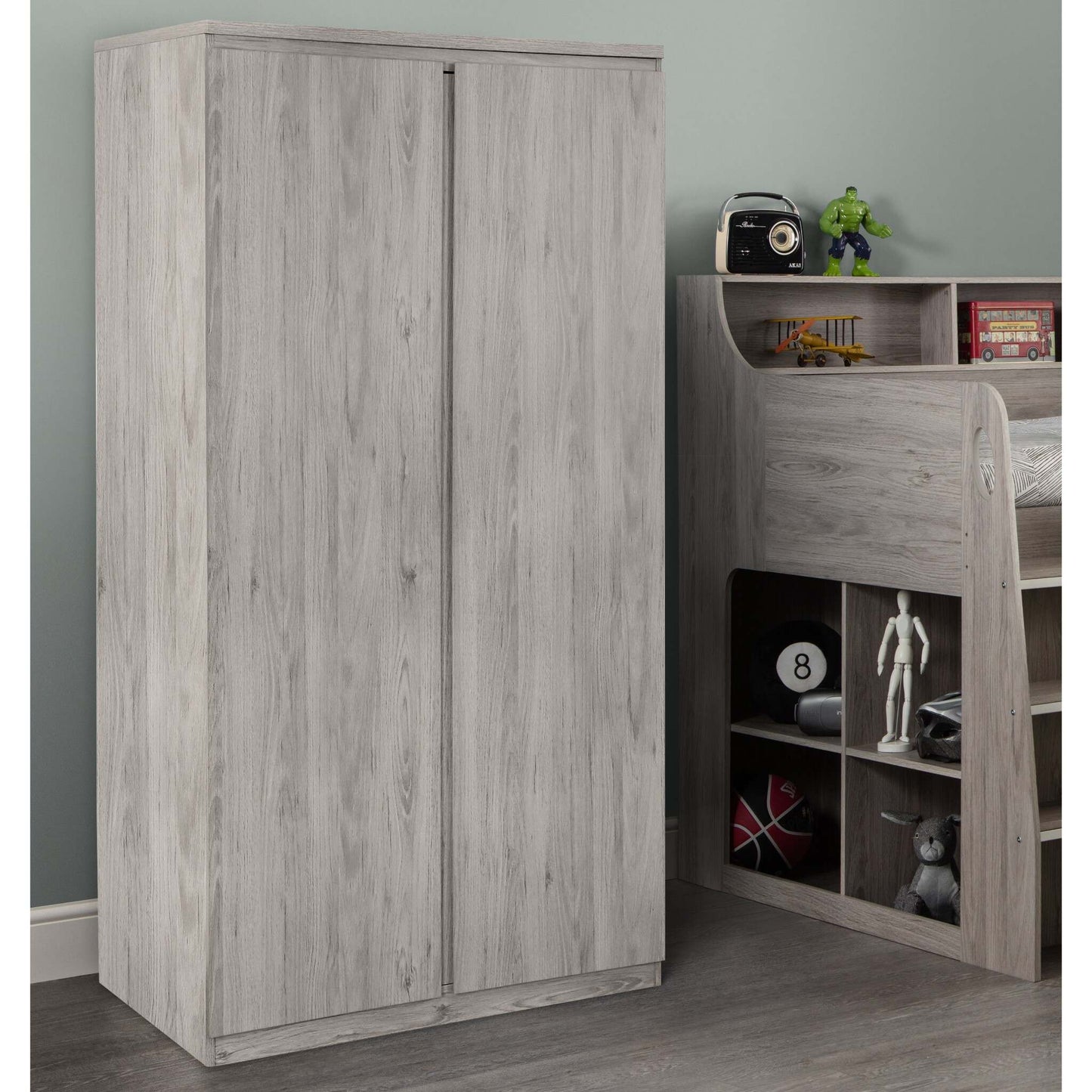 Jupiter 2-Door Wardrobe in grey oak next to the matching Jupiter Mid Sleeper Bed, in a bedroom setting
