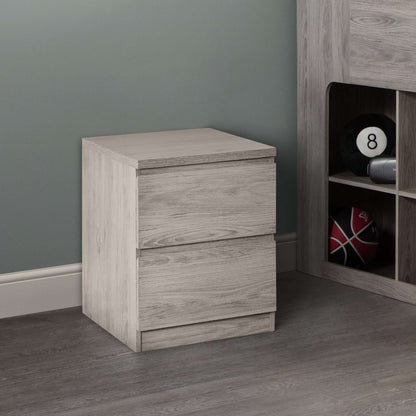 A grey oak 2-drawer bedside from the Jupiter bedroom range, in a room setting