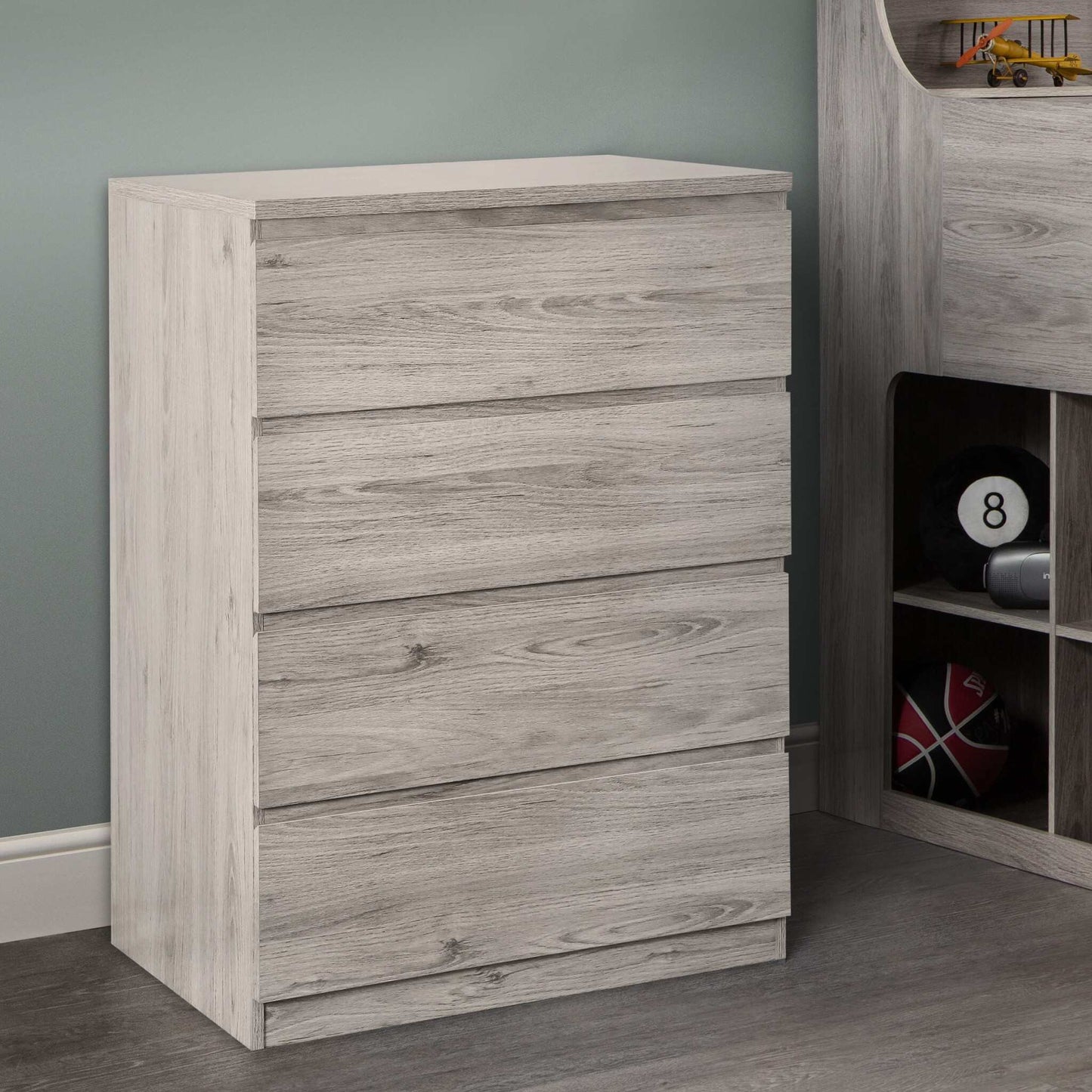 A grey oak 4-drawer chest from the Jupiter bedroom range, in a room setting