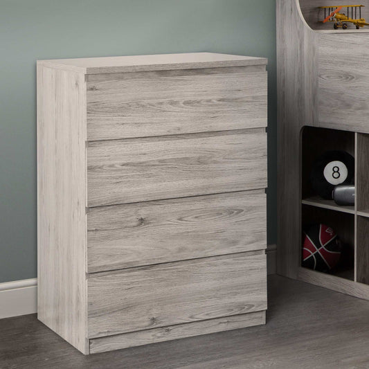 A grey oak 4-drawer chest from the Jupiter bedroom range, in a room setting