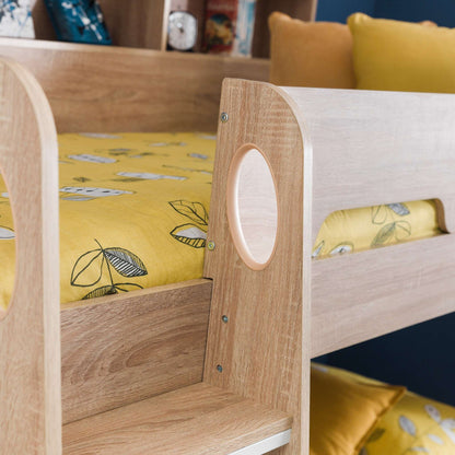 Ladder hand hole and safety rail detail of this children's bunk bed in sonoma oak