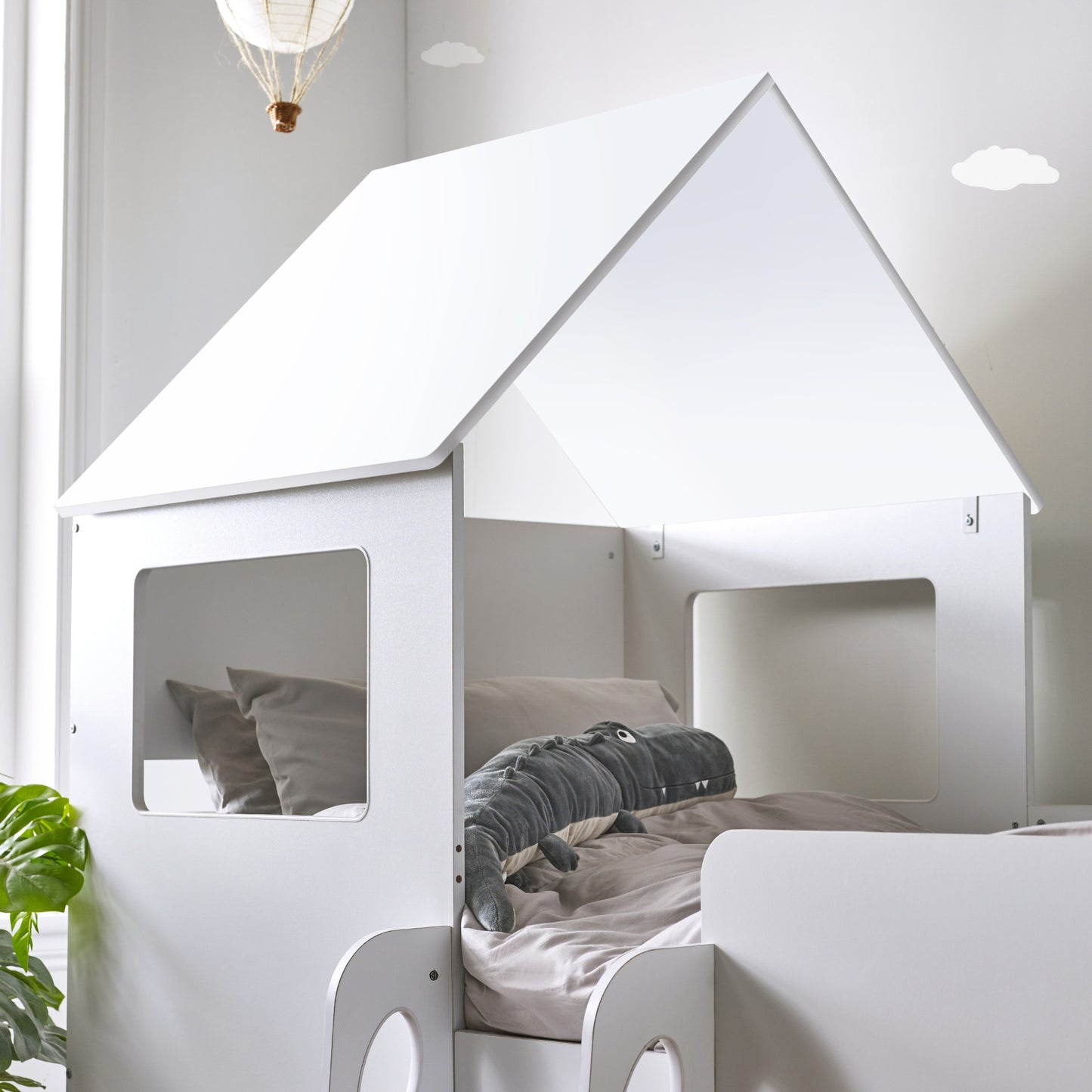 Apex roof and window detail of this children's mid sleeper house bed in white