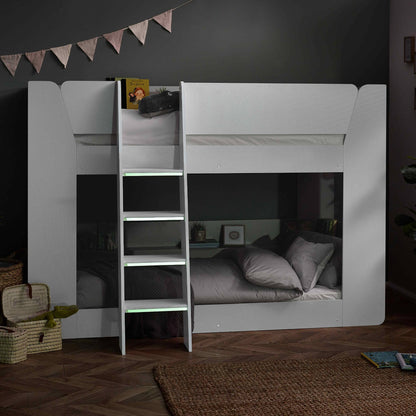 Parsec Bunk Bed in white shown in low lighting with luminous steps on show