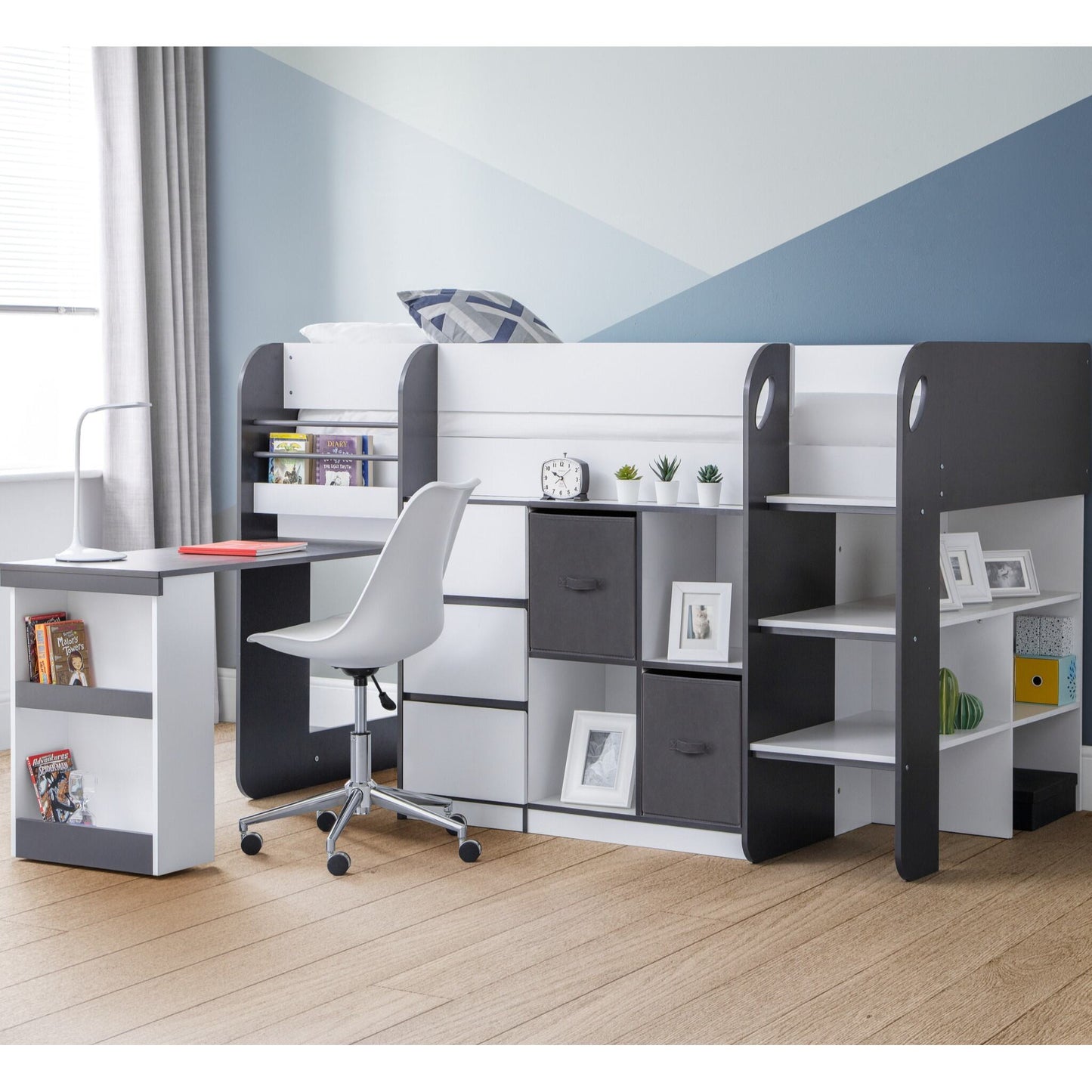 Saturn Mid Sleeper Bed in charcoal with pull-out desk extended in a child's bedroom
