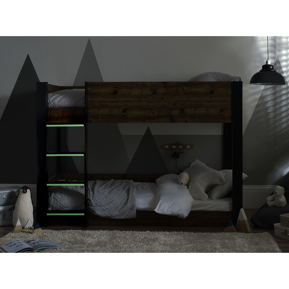 Solomon Bunk Bed with an urban rustic finish shown in low lighting with luminous steps on show