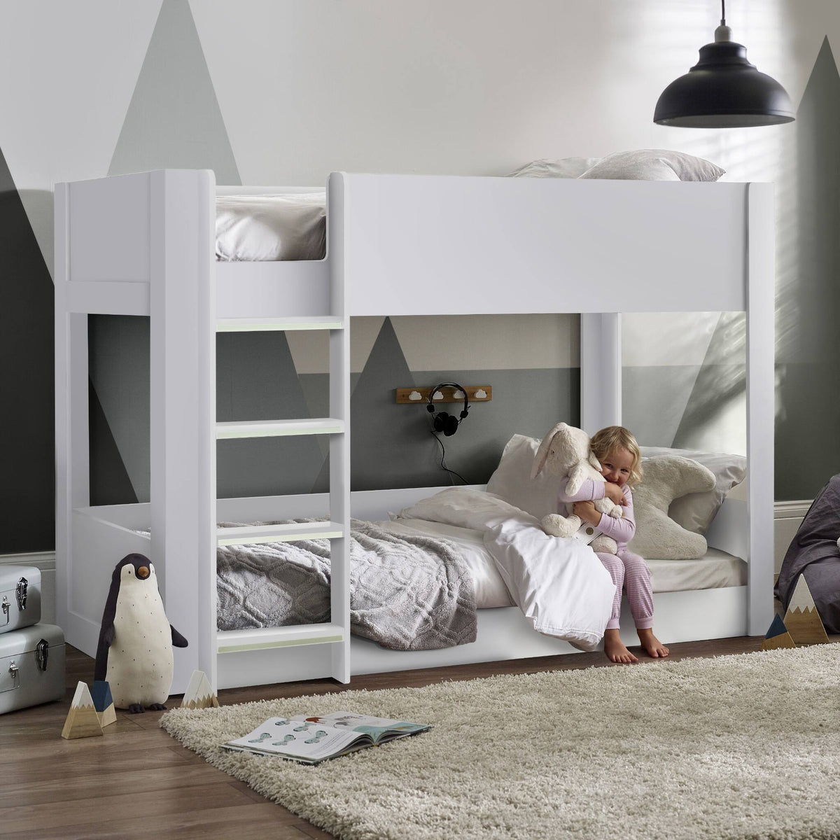 Solomon Bunk Bed with a white finish and low-level design shown in a child’s bedroom setting